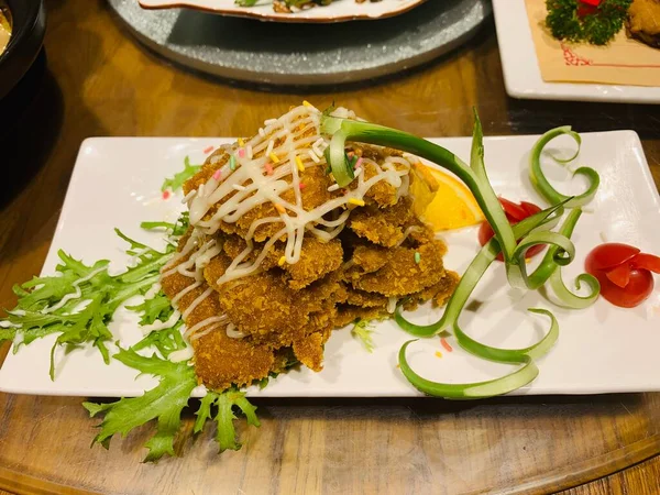 fried fish with vegetables and sauce