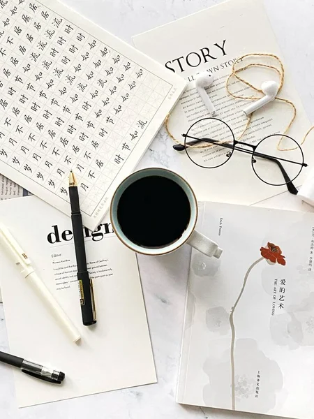 cup of coffee and pen on a white background