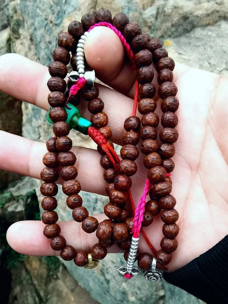 close up of a woman holding a rosary beads