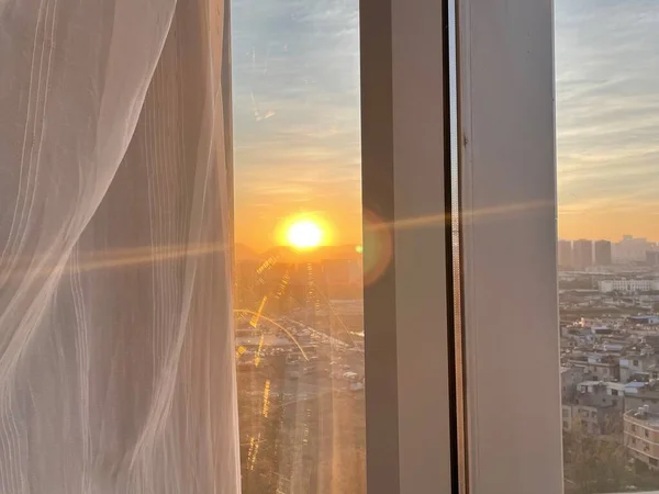 sunset over the window of the city