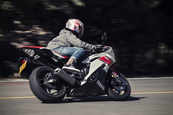 a man rides a motorcycle in the city