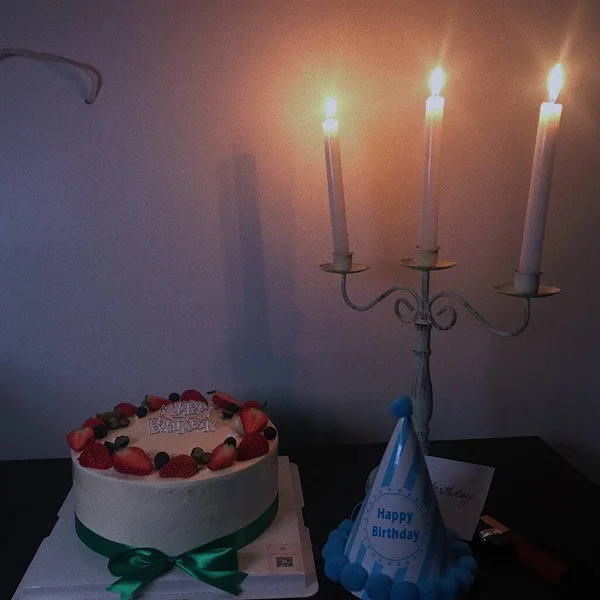 birthday cake with candles and candle on a table