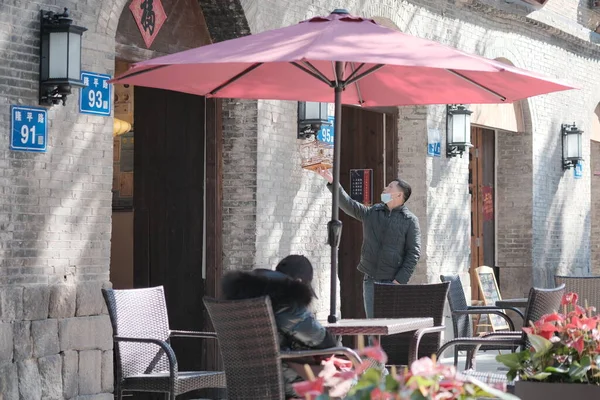 a couple in a cafe with a umbrella