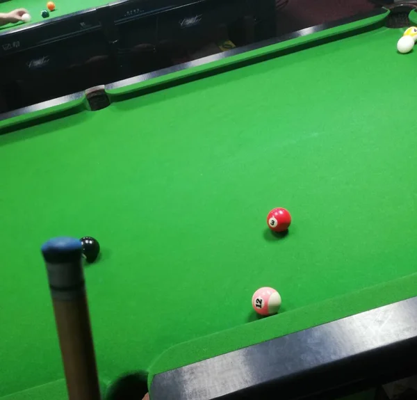 billiard ball on green pool table