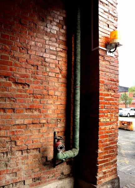 red brick wall with a metal handle