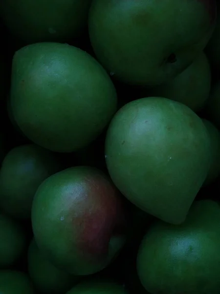 green and white fruits on a black background