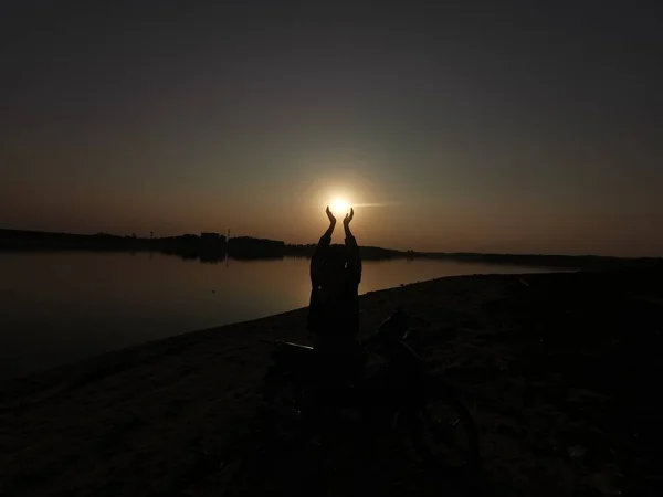 silhouette of a man on the lake