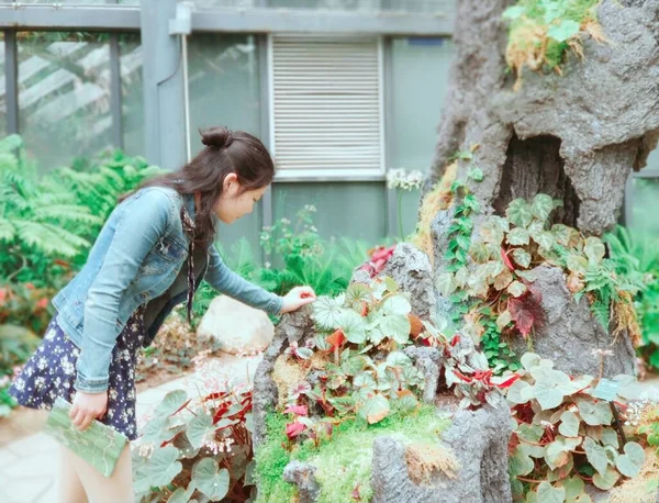 young woman with a toy house