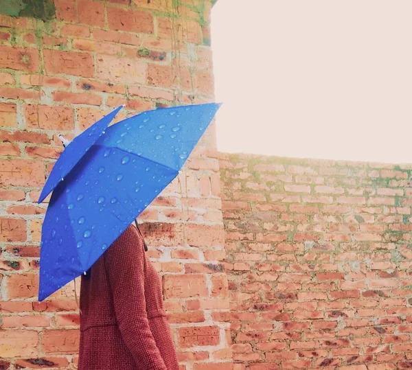 young woman with umbrella on the street