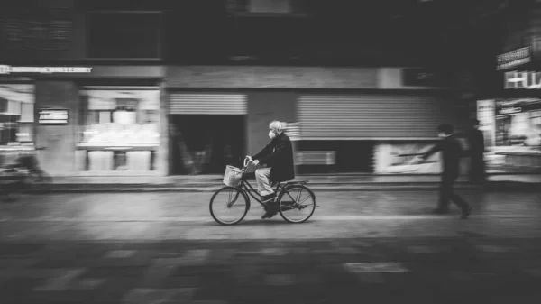 black and white photo of a young man and woman in the city