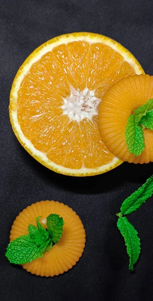 fresh orange and mint slices on black background