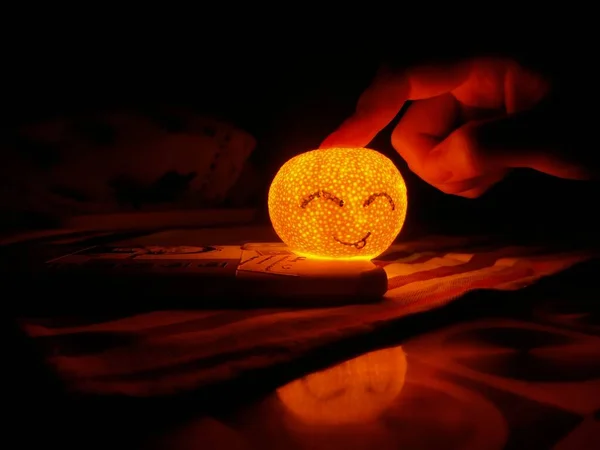 halloween pumpkin with candle in hands