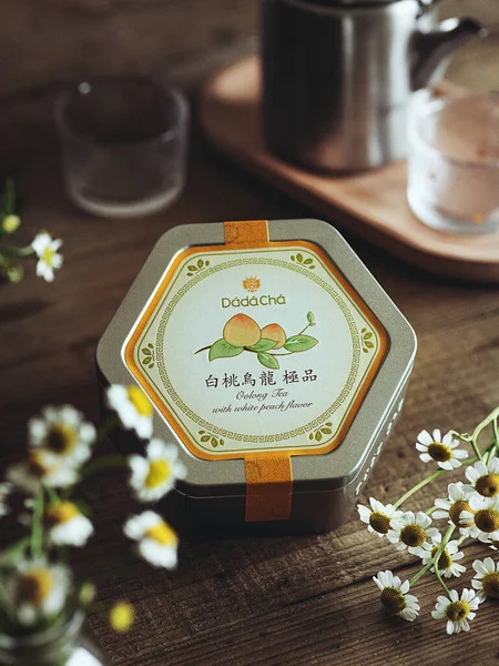 tea cup with flowers and teapot on wooden table