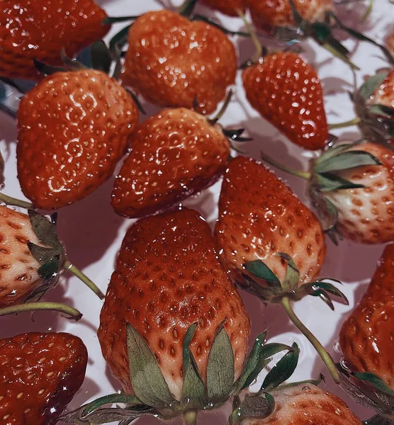 close up of a red and white strawberry