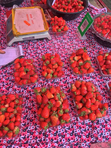 fresh red and white strawberries in a market