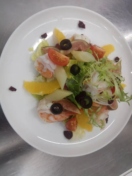 salad with salmon, avocado, olives and cheese