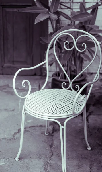 vintage chair and table with white chairs and flowers