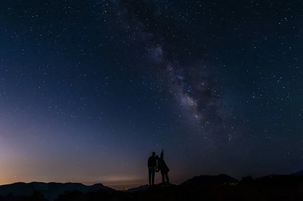 silhouette of a man standing on a rock with a star on a background of stars