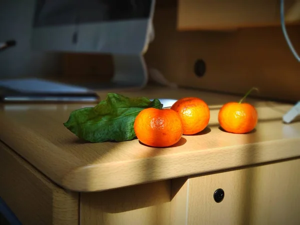 fresh orange and yellow oranges on a wooden table