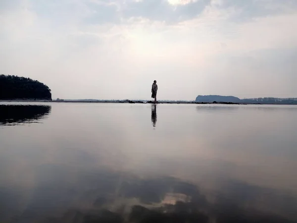 silhouette of a man on the lake