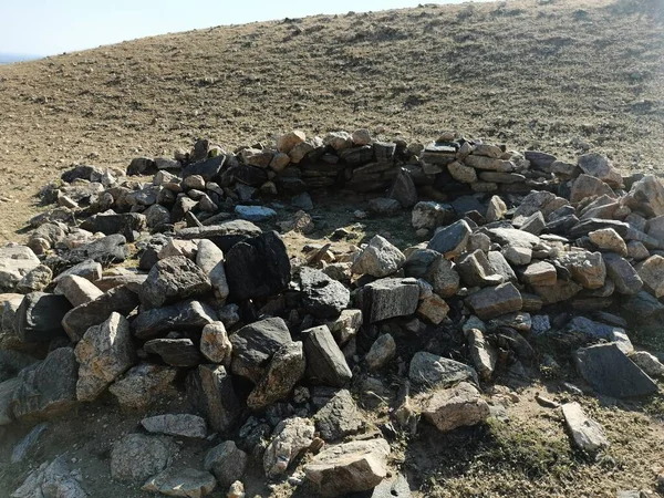 a pile of stones on the rocks of the mountain
