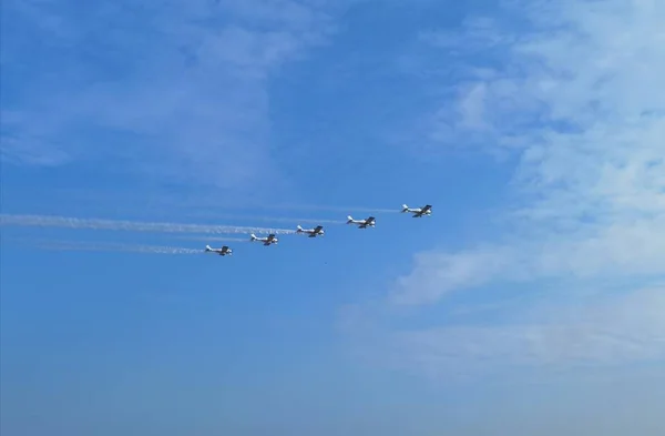 a flock of flying planes in the sky