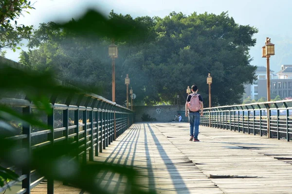 couple walking on the bridge in the city park