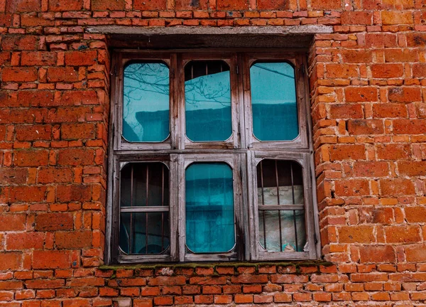 old brick wall with windows and window