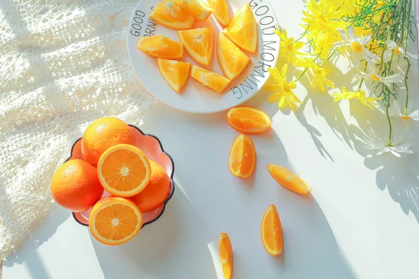 fresh orange and yellow slices of citrus fruits on a white background.