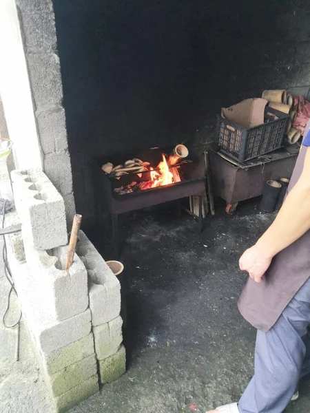 a man is sitting in a restaurant with a fireplace and a fire