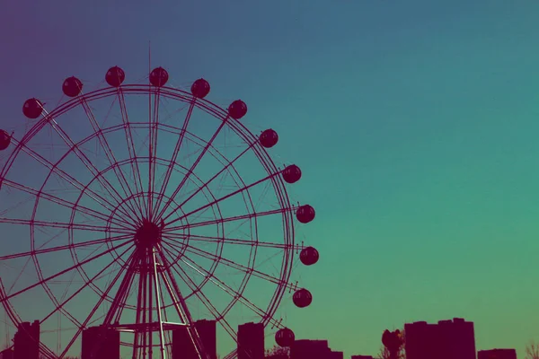 ferris wheel in amusement park, london, uk