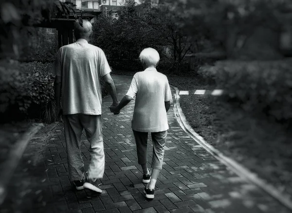 old couple walking in the park