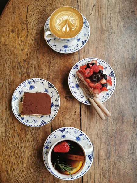 breakfast with a cup of coffee and berries on a wooden background