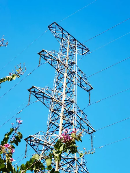 high voltage power line on blue sky background