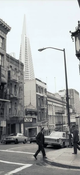 black and white photo of a man in the city