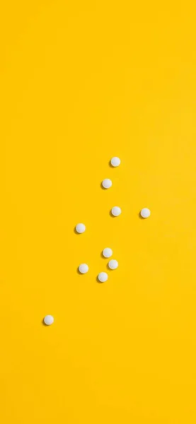 yellow pills on a blue background. top view. copy space.