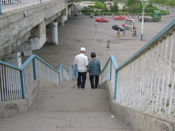 the man is walking along the street