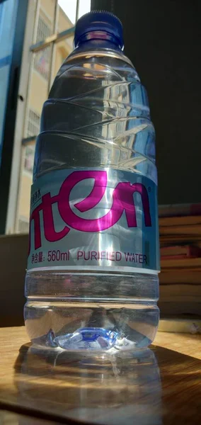 a bottle of water in a glass jar
