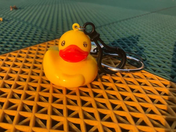 toy duck with rubber ducks on the beach