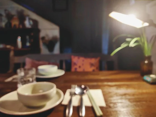 empty table with kitchen interior, blurred background