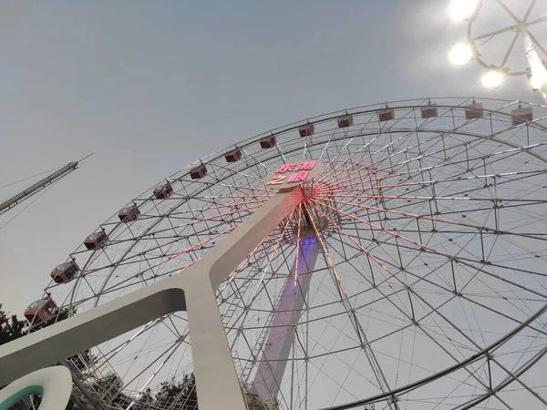 ferris wheel in amusement park, london, uk