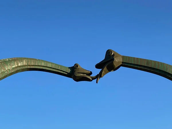 a closeup shot of a rusty metal detector with a blue sky background