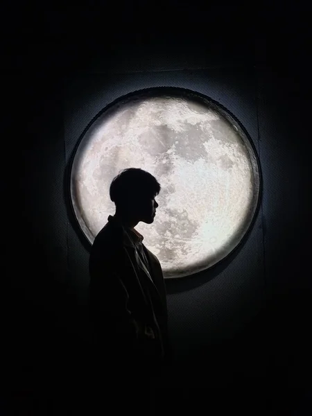 man in black dress with moon