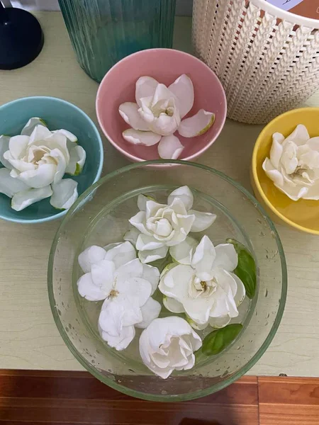 beautiful white flowers in a bowl on a wooden table