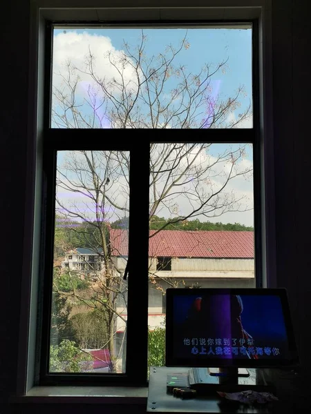 the tv screen in the window of the house