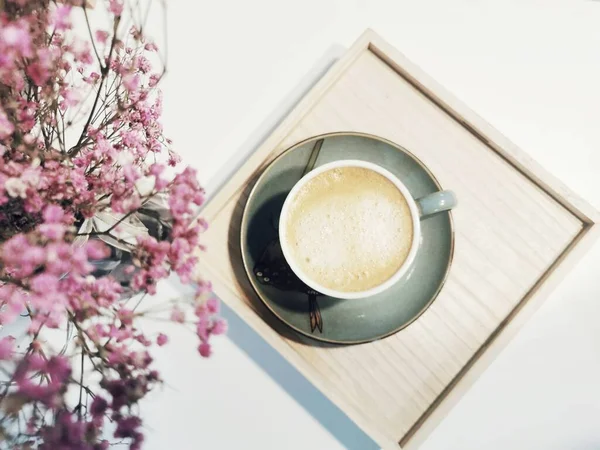 cup of coffee and flowers on a white background