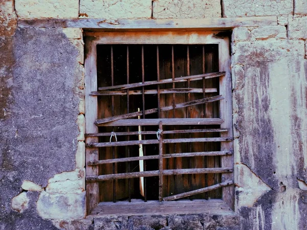 old wooden window with a white wall