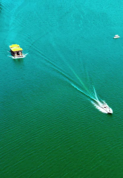 aerial view of the sea, the ship is floating in the water.