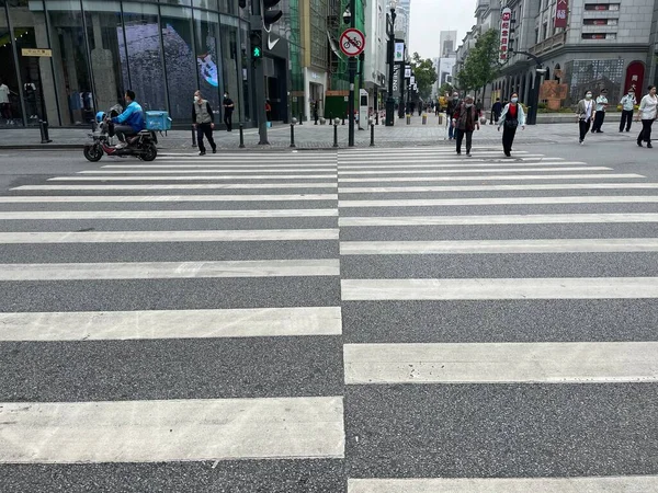 pedestrian crossing the street in the city of barcelona