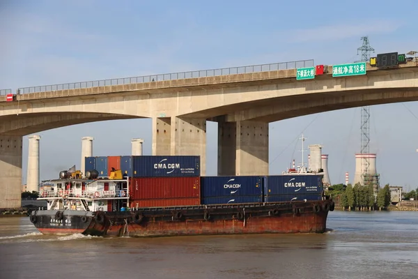 the cargo ship is a large bridge in the port of riga.